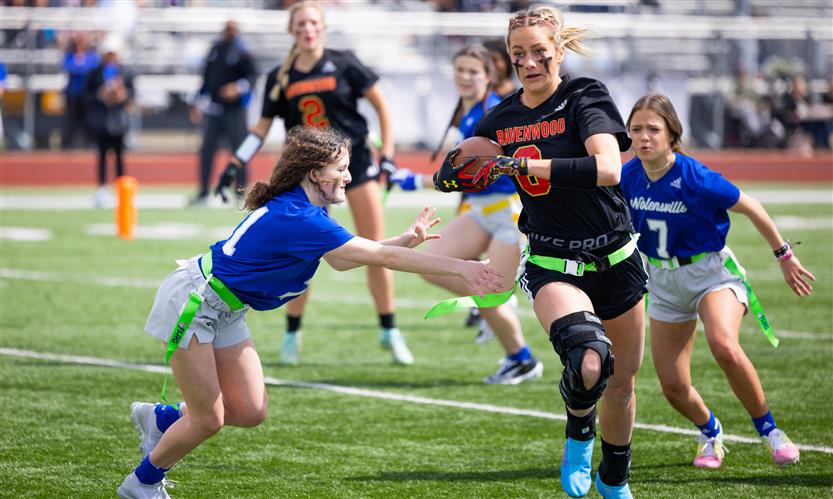 Girls play flag football